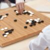YMI Bamboo 0.8-Inch Reversible 19x19 / 13x13 Go Game Set Board with Double Convex Korean Hardened Glass Paduk Go Stones and Jujube Bowls - Image 2